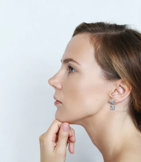 stunning round diamond drop earrings accented with a baguette halo